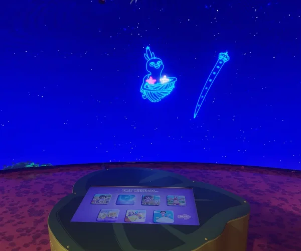 Niño usando la pantalla táctil para controlar la pantalla LED de Dora.