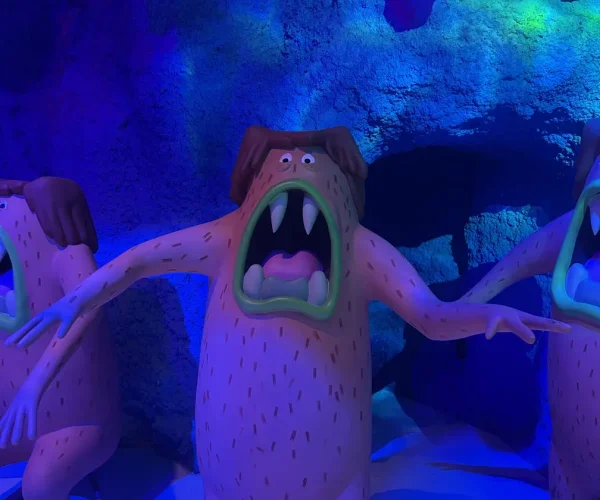 A cave-dweller character with an open mouth ready to surprise visitors